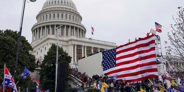 Trump supporters gather outside the Capitol, Wednesday, Jan. 6, 2021, in Washington. As Congress prepares to affirm President-elect Joe Biden's victory, thousands of people have gathered to show their support for President Donald Trump and his claims of election fraud. (AP Photo/John Minchillo)