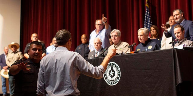 Democrat Beto O'Rourke, who is running against Texas Gov. Greg Abbott for governor this year, interrupts a news conference headed by Abbott in Uvalde, Texas, Wednesday, May 25, 2022.
