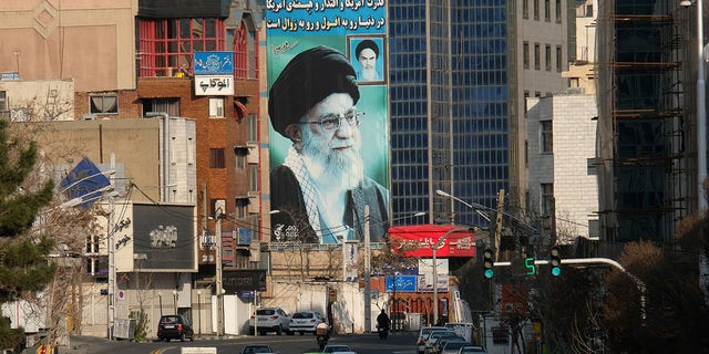 March 08, 2020: A huge mural of Ayatollah Seyyed Ali Khamenei Iran's Supreme Leader painted next to a smaller one of Ayatollah Ruhollah Khomeini (R) seen on Motahari street on March 8, 2020 in Tehran, Iran. The message on the wall reads "The power and influence and dignity of America in the world is on the fall and extermination" and on top of the building, another slogan reads "We are standing till the end".