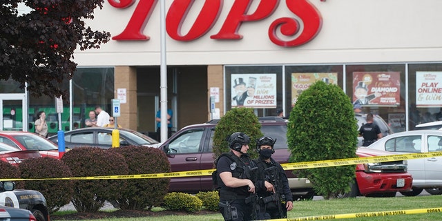 Police secure an area around a supermarket where several people were killed in a shooting, Saturday, May 14, 2022 in Buffalo, N.Y. Officials said the gunman entered the supermarket with a rifle and opened fire. Investigators believe the man may have been livestreaming the shooting and were looking into whether he had posted a manifesto online (Derek Gee/The Buffalo News via AP)