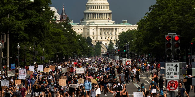 Demonstrators walk towards the White House and away from the U.S. Capitol Building during a protest against the death in Minneapolis police custody of George Floyd, in Washington, U.S., June 6, 2020.