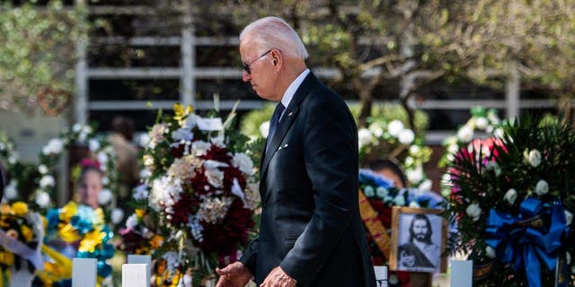 US President Joe Biden pays respect at a makeshift memorial outside of Robb Elementary School in Uvalde, Texas on May 29, 2022. 