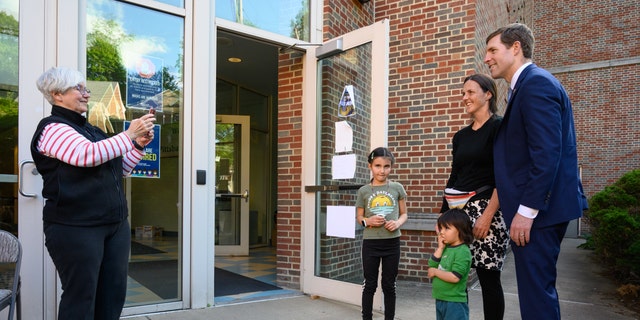 Conor Lamb, US Democratic Senate candidate, takes a photo with a voter and her children, at a polling location in Pittsburgh, Pennsylvania, US, on Tuesday, May 17, 2022.  