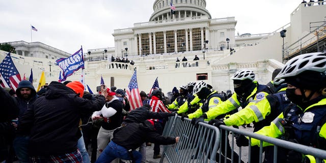 Trump supporters try to break through a police barrier, Wednesday, Jan. 6, 2021, at the Capitol in Washington. 