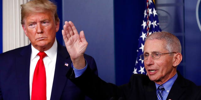 President Donald Trump listens as Dr. Anthony Fauci, director of the National Institute of Allergy and Infectious Diseases, speaks about the coronavirus in the James Brady Briefing Room, Tuesday, March 24, 2020, in Washington. 