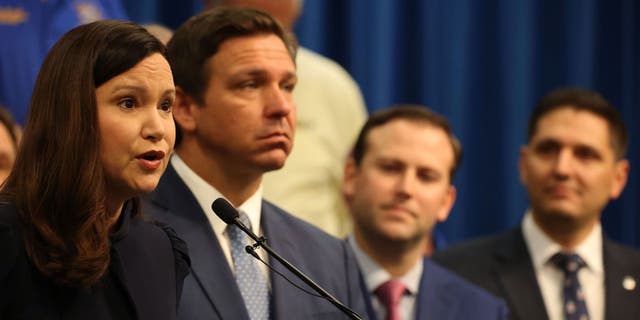 Florida Attorney General Ashley Moody and Florida Gov. Ron DeSantis at a news conference on April 19, 2021.