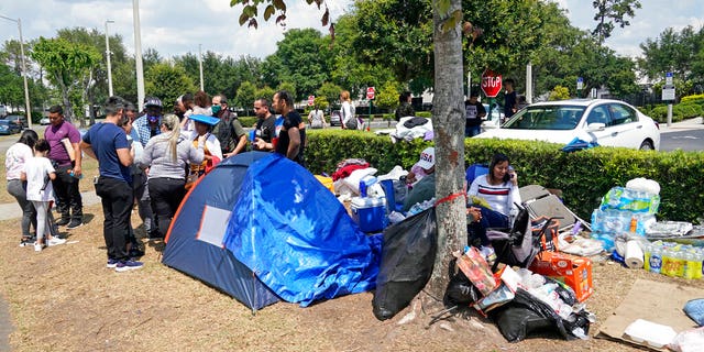 May 2, 2022: People wait outside the Orlando Immigration and Customs Enforcement facility in order to get appointments with federal immigration officials in Orlando, Fla.