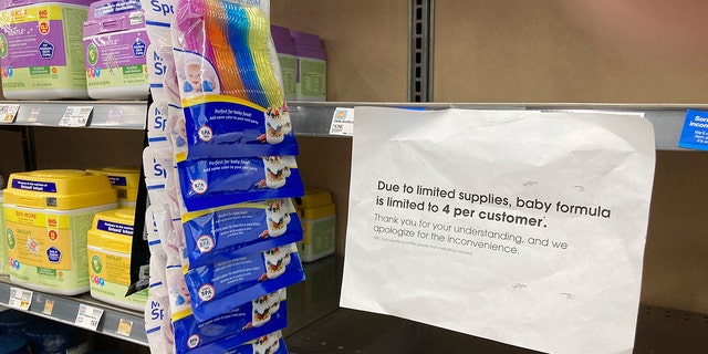 A sign telling consumers of limits on the purchase of baby formula hangs on the edge of an empty shelf for the product in a King Soopers grocery store, Wednesday, May 11, 2022, in southeast Denver. 