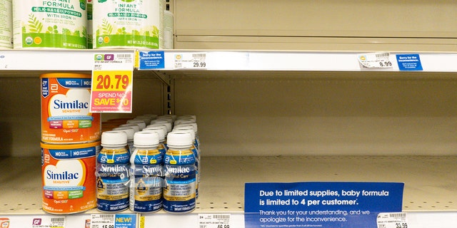 Baby formula is displayed on the shelves of a grocery store with a sign limiting purchases in Indianapolis, Tuesday, May 10, 2022. 