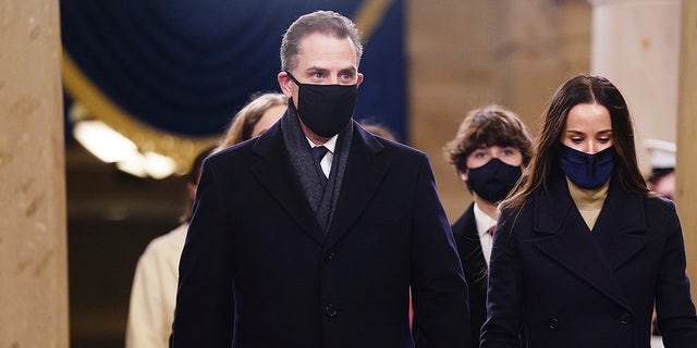 Hunter Biden, left, arrives in the Crypt of the U.S. Capitol for President-elect Joe Biden's inauguration Jan. 20, 2021 in Washington.