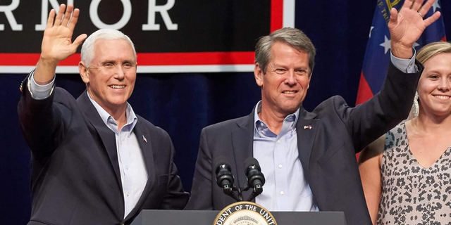FILE - Former Vice President Mike Pence and Georgia Gov. Brian Kemp team up on the campaign trail in Dalton, Georgia in November 2018.