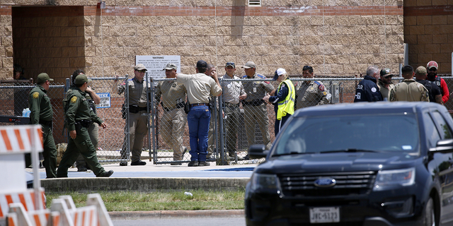 Law enforcement, and other first responders, gather outside Robb Elementary School following a shooting on Tuesday, May 24, 2022, in Uvalde, Texas.