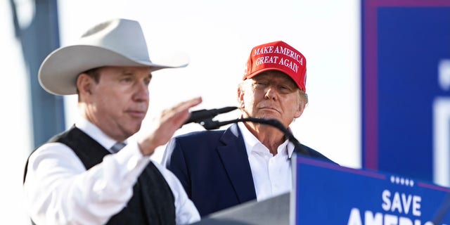 Republican gubernatorial candidate Charles Herbster speaks while former President Donald Trump stands by, at a rally in Greenwood, Nebraska, on May 1, 2022.