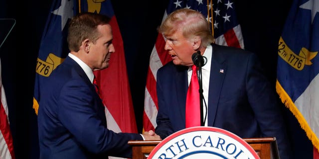 Former President Donald Trump, right, announces his endorsement of N.C. Rep. Ted Budd, left, for the 2022 North Carolina U.S. Senate seat as he speaks at the North Carolina Republican Convention Saturday, June 5, 2021, in Greenville, N.C. (AP Photo/Chris Seward)