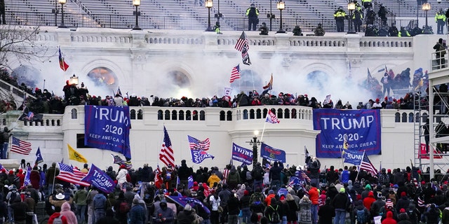 FILE - In this Jan. 6, 2021 file photo, violent protesters, loyal to President Donald Trump, storm the Capitol in Washington. (AP Photo/John Minchillo)
