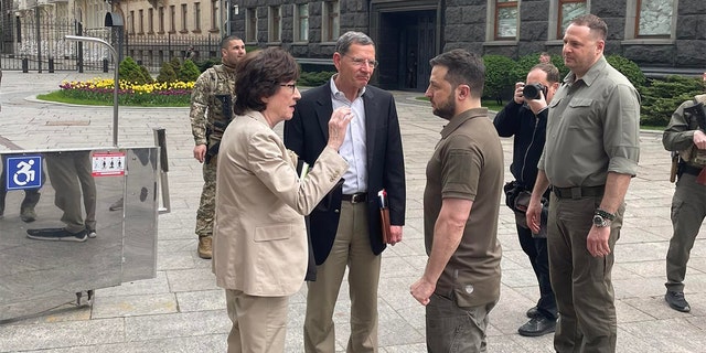 Ukrainian President Volodymy Zelenskyy speaks with Republican Sens. Susan Collins of Maine and John Barrasso of Wyoming, Saturday, May 14, 2022.