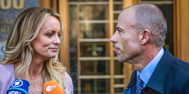 Adult film actress Stormy Daniels, left, stands with her lawyer Michael Avenatti during a news conference outside federal court in New York, April 16, 2018.