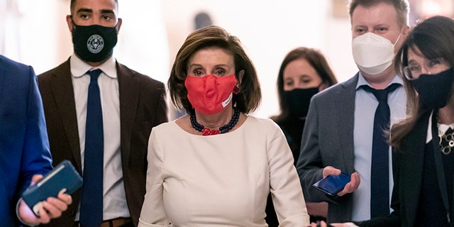House Speaker Nancy Pelosi walks with reporters at the Capitol on Nov. 4, 2021. (AP Photo/J. Scott Applewhite)