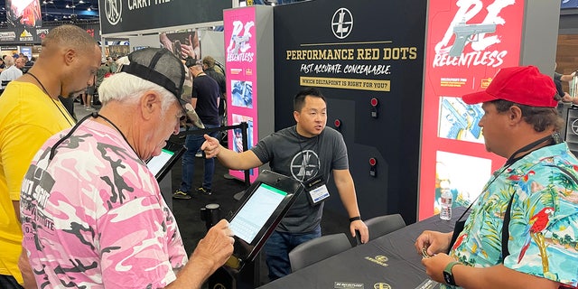 Different booths are shown on the exhibit floor of the 2022 NRA convention in Houston.