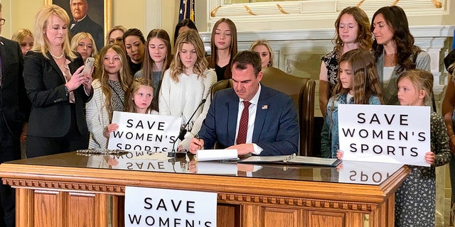 Oklahoma Gov. Kevin Stitt signs a bill in Oklahoma City March 30, 2022, that prevents transgender girls and women from competing on female sports teams. 