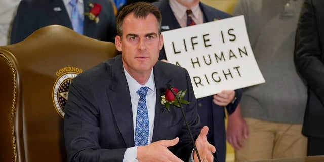 Oklahoma Gov. Kevin Stitt speaks after signing into law a bill making it a felony to perform an abortion, punishable by up to 10 years in prison, April 12, 2022, in Oklahoma City.