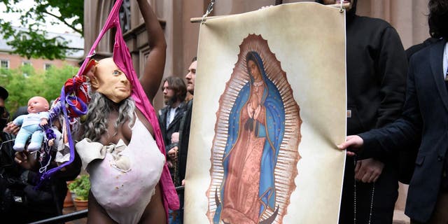 Pro-life activists and church members are confronted by a pro-choice activist outside a Catholic church in Manhattan.