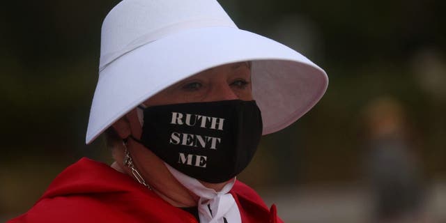 Woman dressed in a Handmaid's Tale costume takes part in a pro-abortion rights protest outside of the U.S. Supreme Court building in Washington, U.S., Oct. 4, 2021. 