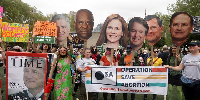 Protesters hold up signs during a pro-choice demonstration, Saturday, May 14, 2022, in New York.