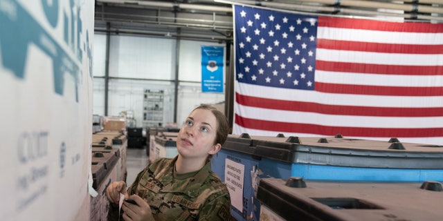 U.S. Air Force Airman Megan Konsmo, from Tacoma, Wash., checks pallets of equipment ultimately bound for Ukraine in the Super Port of the 436th Aerial Port Squadron, Friday, April 29, 2022, at Dover Air Force Base, Del. 