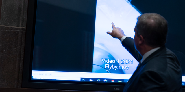 Deputy Director of Naval Intelligence Scott Bray points to a video display of a UAP during a hearing of the House Intelligence, Counterterrorism, Counterintelligence, and Counterproliferation Subcommittee hearing on "Unidentified Aerial Phenomena"