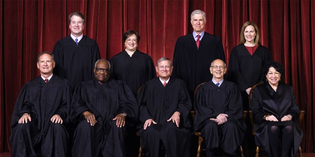 FILE - In this April 23, 2021, file photo members of the Supreme Court pose for a group photo at the Supreme Court in Washington. Seated from left are Associate Justice Samuel Alito, Associate Justice Clarence Thomas, Chief Justice John Roberts, Associate Justice Stephen Breyer and Associate Justice Sonia Sotomayor, Standing from left are Associate Justice Brett Kavanaugh, Associate Justice Elena Kagan, Associate Justice Neil Gorsuch and Associate Justice Amy Coney Barrett. (Erin Schaff/The New York Times via AP, Pool, File