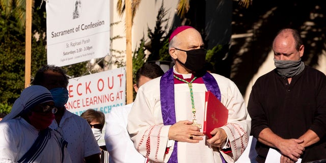 San Francisco's Archbishop Salvatore Cordileone conducts an exorcism Saturday, Oct. 17, 2020, outside of Saint Raphael Catholic Church in San Rafael, Calif., on the spot where a statue of St. Junipero Serra was toppled during a protest on Oct. 12. (Jessica Christian/San Francisco Chronicle via AP)