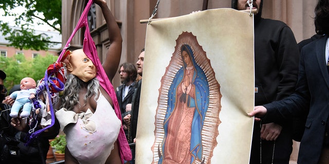 Pro-life activists and church members are confronted by a pro-choice activist outside of a Catholic church in downtown Manhattan on May 7, 2022.