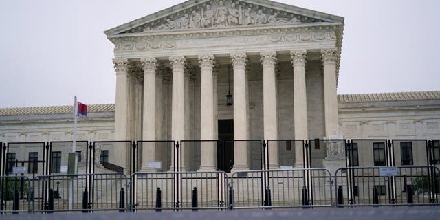 Security fencing is in place outside the Supreme Court in Washington, Saturday, May 14, 2022, ahead of expected abortion right rallies later in the day. 