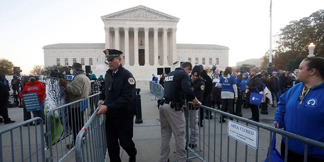 Supreme Court Police officers erect a barrier between anti-abortion and pro-abortion rights protesters ahead of arguments in the Mississippi abortion rights case in Washington, Dec. 1, 2021.
