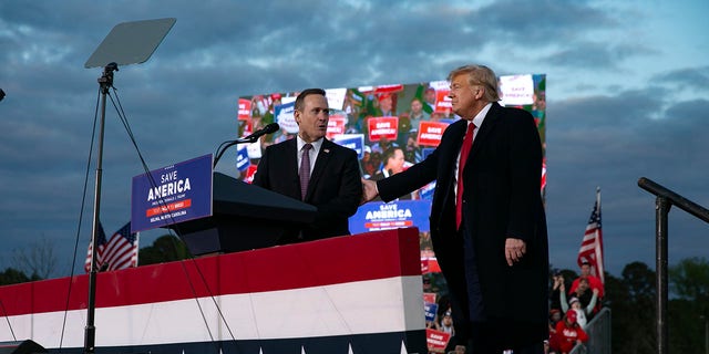 Ted Budd, who is running for U.S. Senate, joins the stage with former U.S. President Donald Trump during a rally at The Farm at 95 on April 9, 2022, in Selma, North Carolina.
