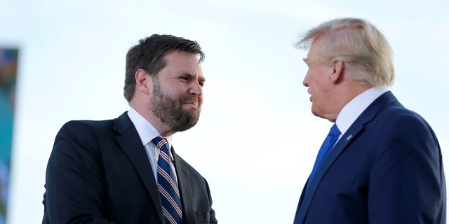 Senate candidate JD Vance, left, greets former President Donald Trump at a rally at the Delaware County Fairgrounds, Saturday, April 23, 2022, in Delaware, Ohio, to endorse Republican candidates ahead of the Ohio primary on May 3.  (AP Photo/Joe Maiorana, File)