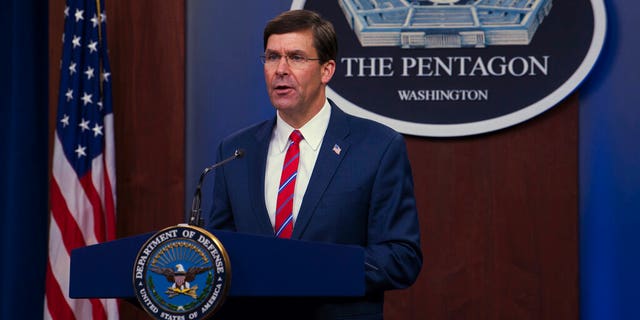 Former Defense Secretary Mark Esper speaks to members of the media during a news conference at the Pentagon Briefing Room in Washington, on Monday, March 23, 2020. 