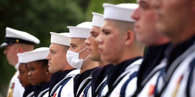FILE: Members of the Navy Ceremonial Guard stand for the national anthem during a ceremony for National POW/MIA Recognition Day, at the U.S. Navy Memorial on September 17, 2021 in Washington, DC. 