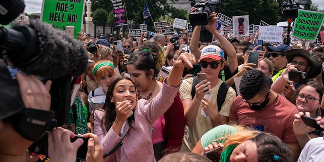 WASHINGTON, DC - JUNE 24: Rep. Alexandria Ocasio-Cortez (D-NY) speaks to abortion-rights activists in front of the U.S. Supreme Court after the Court announced a ruling in the Dobbs v Jackson Women's Health Organization case on June 24, 2022 in Washington, DC.  