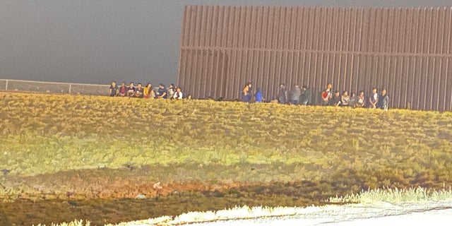 Border Patrol apprehends a group of migrants near a section of the border wall near Hidalgo, Texas. 