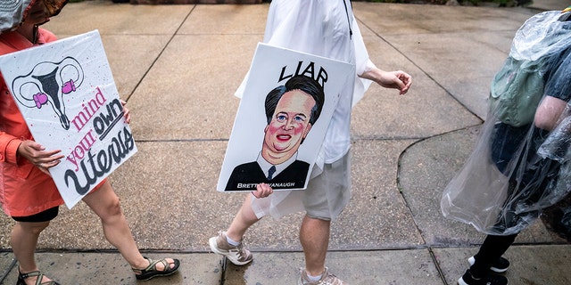 Protesters march past Supreme Court Justice Brett Kavanaugh's home on June 8, 2022, in Chevy Chase, Maryland. 