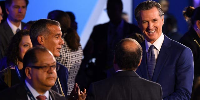 Los Angeles Mayor Eric Garcetti (2nd L) speaks to California Governor Gavin Newsom (R) ahead of a plenary session during the 9th Summit of the Americas in Los Angeles, California, June 9, 2022.