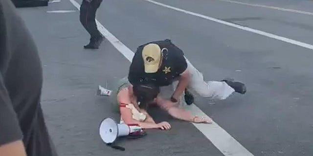 A protester who walked in front of President Biden's motorcade on Wednesday was tackled by the Secret Service in Los Angeles. 