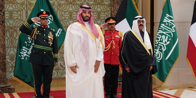 Kuwaiti Crown Prince Sheikh Mishal Al-Ahmad Al-Jaber Al-Sabah R, Front welcomes Saudi Arabia's Crown Prince Mohammed bin Salman bin Abdulaziz Al Saud L, Front at an airport in Farwaniya Governorate, Kuwait, on Dec. 10, 2021. )