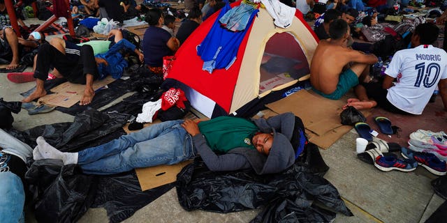 June 10, 2022: Migrants traveling as a group by foot rest at an open-air sports complex in Mapastepec, Chiapas state in southern Mexico. (AP Photo/Marco Ugarte)