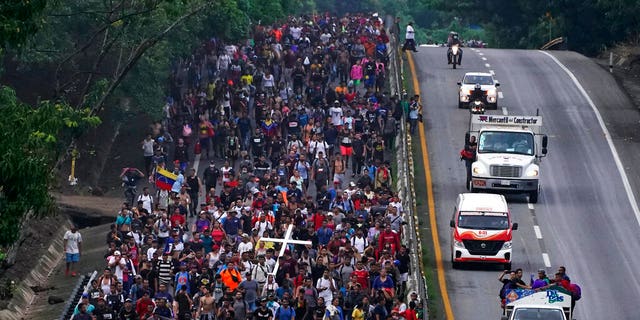 Migrants, many from Central American and Venezuela, walk along the Huehuetan highway in Chiapas state, Mexico, early Tuesday, June 7, 2022. The group left Tapachula on Monday, tired of waiting to normalize their status in a region with little work and still far from their ultimate goal of reaching the United States. (AP Photo/Marco Ugarte)