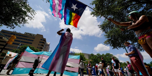 Demonstrators gather on the steps of the State Capitol to speak against transgender-related legislation bills being considered in the Texas Senate and Texas House, May 20, 2021, in Austin, Texas.