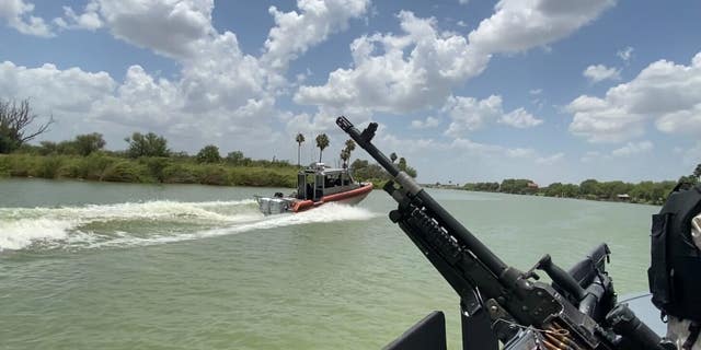 In an image taken from a Texas Department of Public Safety boat, a U.S. Coast Guard vessel patrols the Rio Grande. 