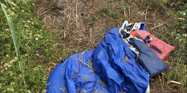 A life vest and a deflated raft are left in the brush on the U.S. side of the Rio Grande, as seen on a tour of the river with the Texas Department of Public Safety. When trafficked heavily, the grass becomes pushed down around these landing areas, creating easily distinguishable paths. 